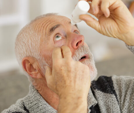 Man applying eye drops for dry eyes