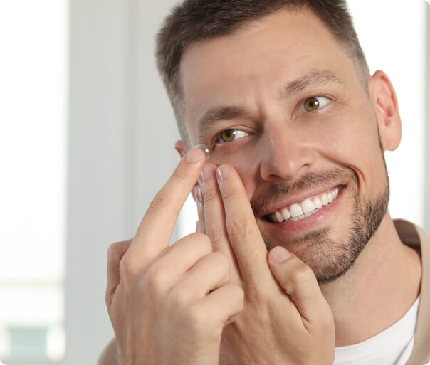 Man putting on contact lens